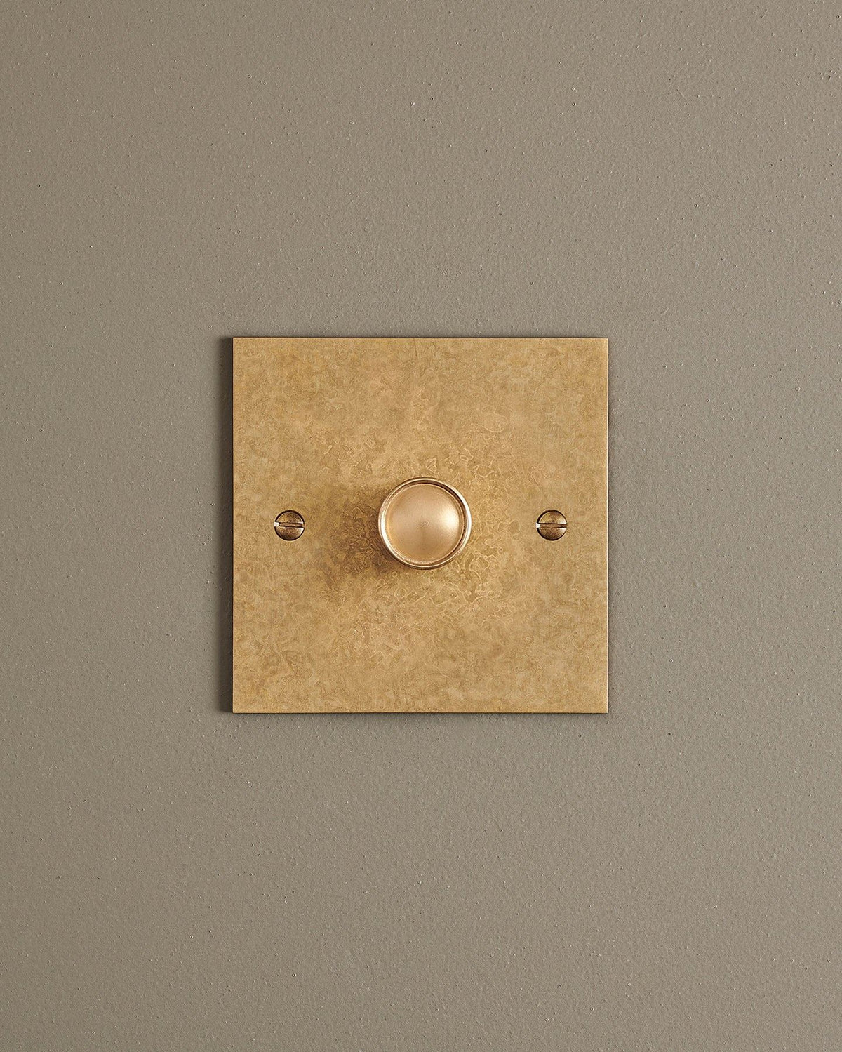 A straight-on view of a 1 gang classic dimmer switch in a mottled aged brass finish. TEST