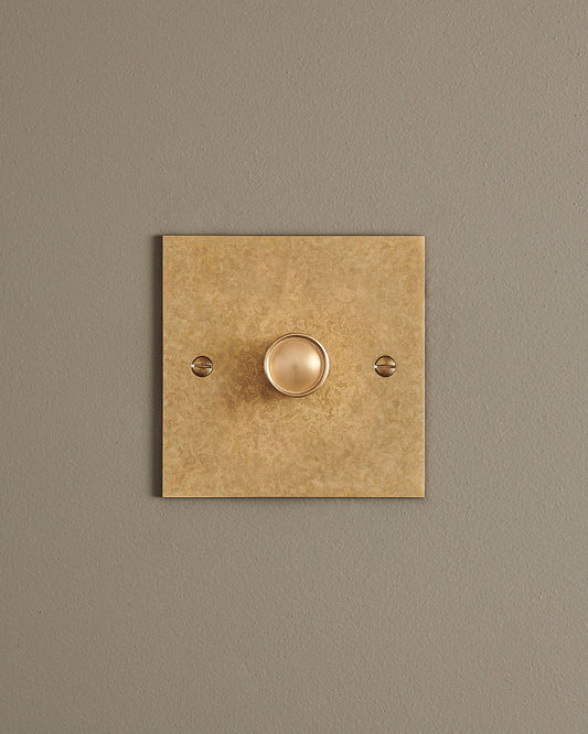A straight-on view of a 1 gang classic dimmer switch in a mottled aged brass finish.