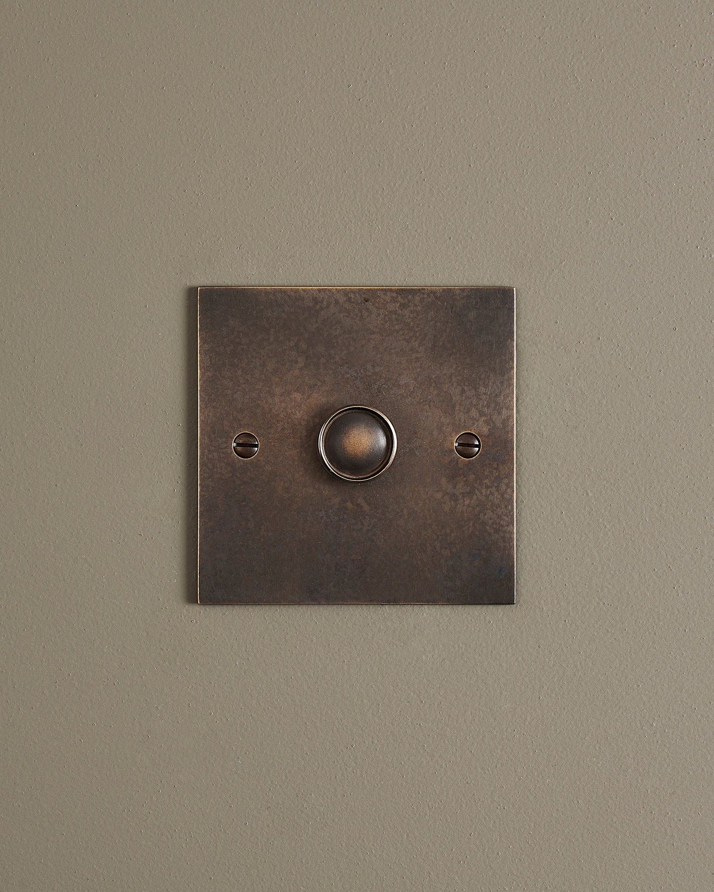 A straight-on view of a 1 gang classic dimmer switch in a dark oxidised brass finish.