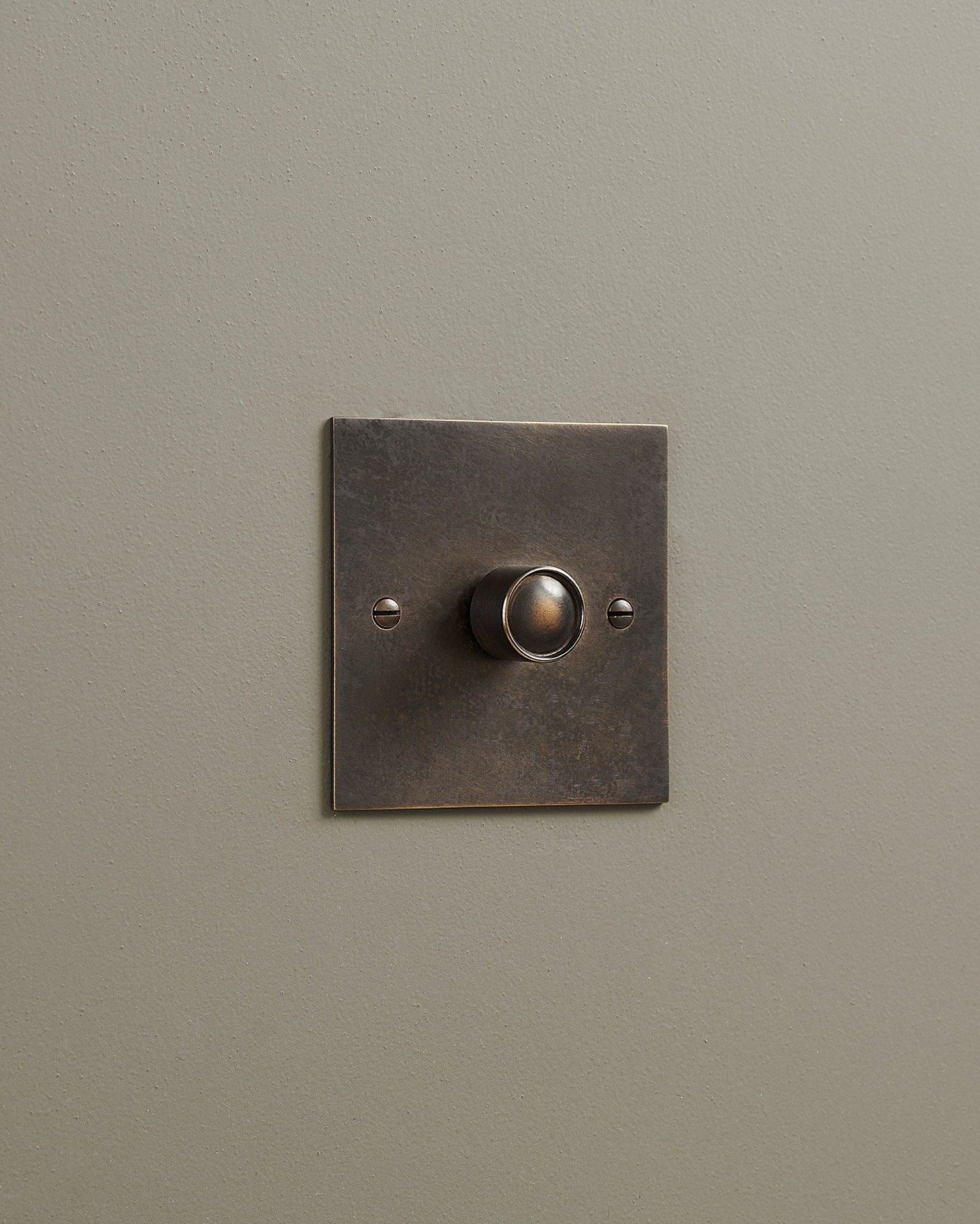 An oblique view of a 1 gang classic dimmer switch in a dark oxidised brass finish.