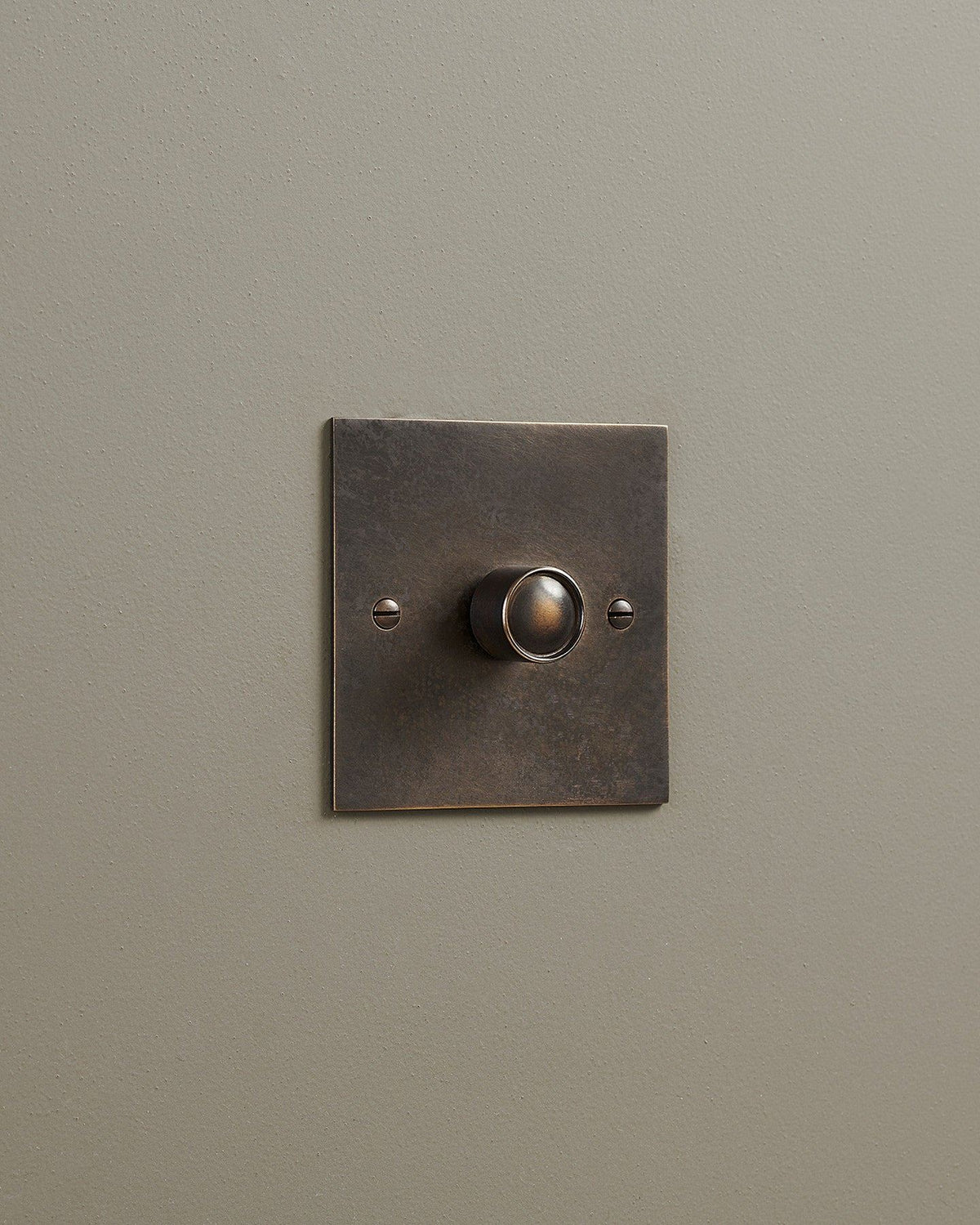An oblique view of a 1 gang classic dimmer switch in a dark oxidised brass finish. TEST