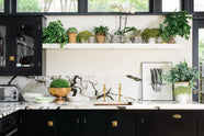 A closer look at the Painter’s Black shake kitchen’s single copper sink with aged brass Mayan taps and a San Simone quartzite worktop and splashback.