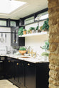 A closer look at the Painter’s Black shake kitchen’s single copper sink with aged brass Mayan taps and a San Simone quartzite worktop and splashback.