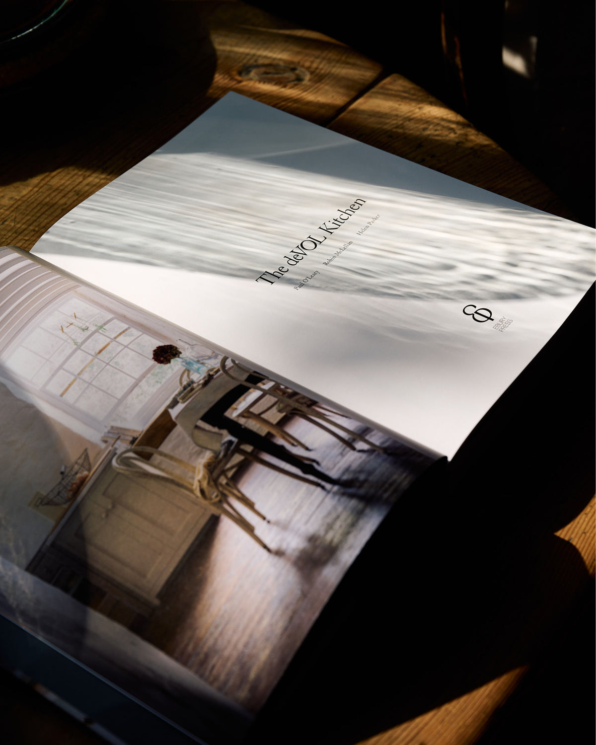 An oblique view of the opened deVOL Kitchen published hardbound book featuring the Cotes Mill Shaker kitchen on the left hand side of the double page spread.